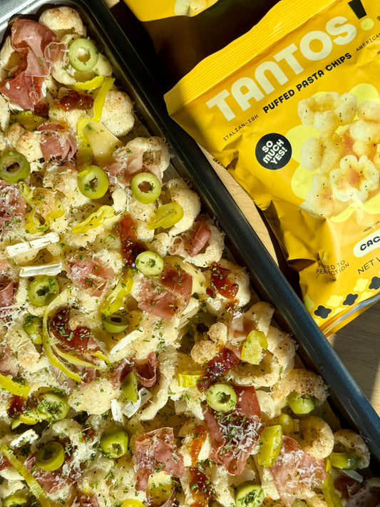 Charcuterie Nachos with Cacio e Pepe Tantos, brie, prosciutto, and hot honey